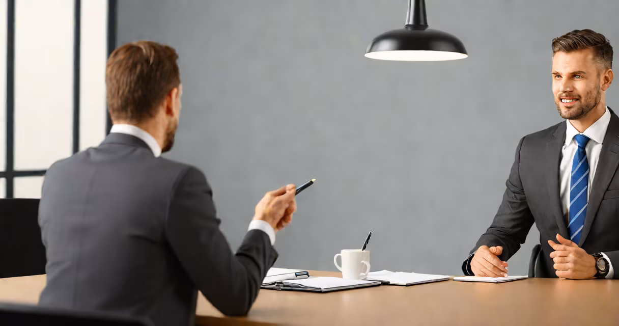 Professional person in business attire answering interview questions in a modern office setting
