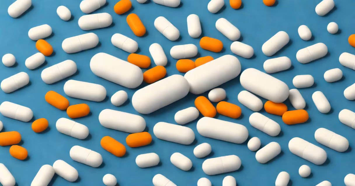 White pill with "CFX" imprint on a blue background, isolated on light gray
